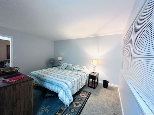 carpeted bedroom featuring baseboards