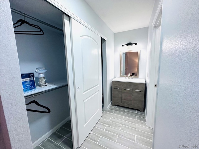 bathroom featuring baseboards and vanity