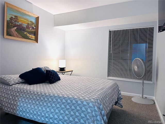 bedroom featuring baseboards and carpet flooring