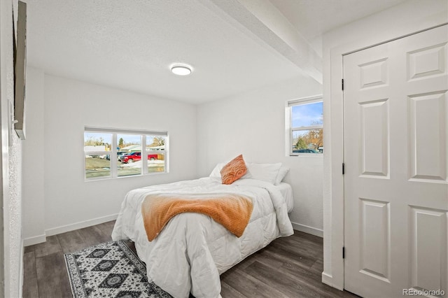 bedroom featuring dark wood-type flooring and a textured ceiling