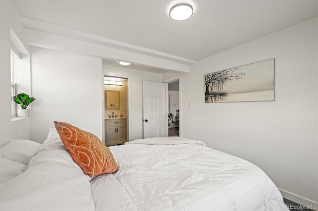 bedroom with sink and connected bathroom