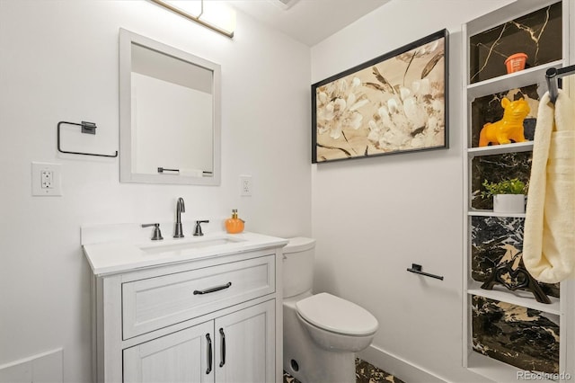 bathroom featuring vanity and toilet