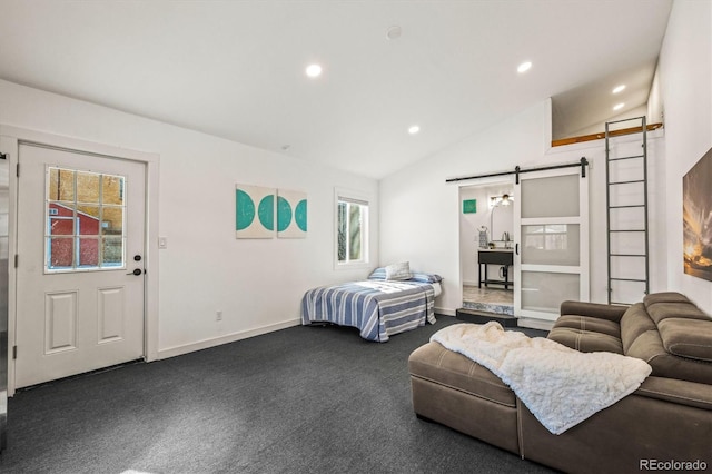 bedroom with dark carpet, vaulted ceiling, and a barn door