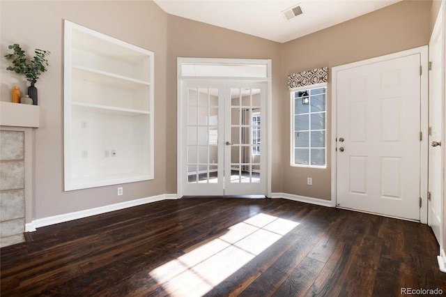 entryway with vaulted ceiling, dark hardwood / wood-style floors, and french doors