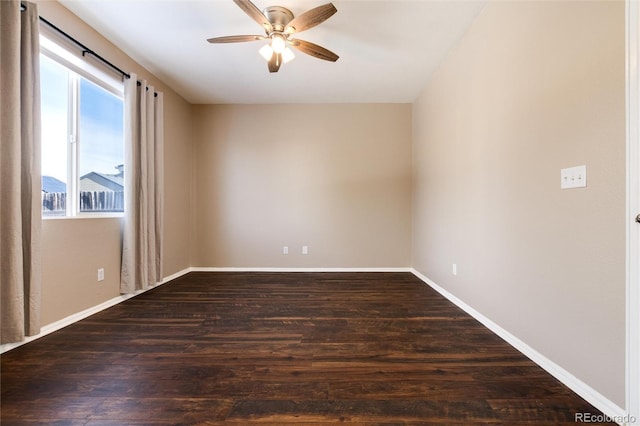 unfurnished room with ceiling fan and dark hardwood / wood-style flooring