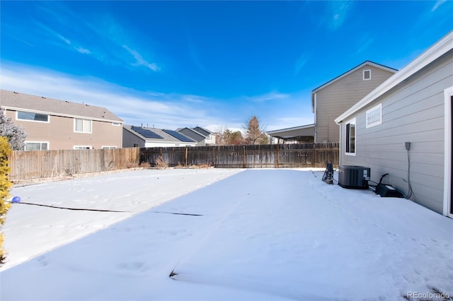 yard layered in snow featuring central AC