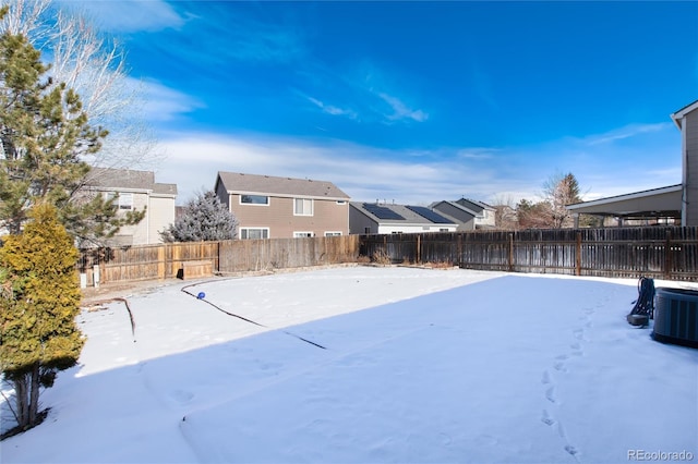 snowy yard with central AC