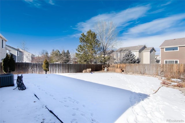 yard covered in snow featuring central AC