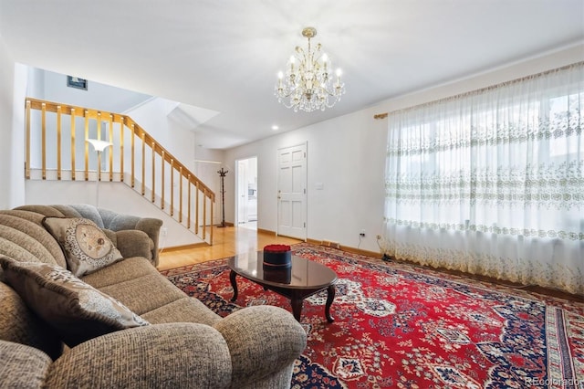 1254 S Yosemite Way Unit 99, Denver, CO 80247 - living room with stairway, a chandelier, wood finished floors, and baseboards