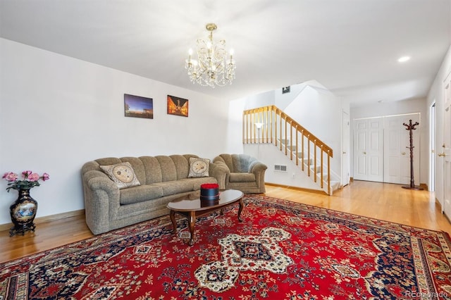 1254 S Yosemite Way Unit 99, Denver, CO 80247 - living area featuring stairway, wood finished floors, a chandelier, and baseboards