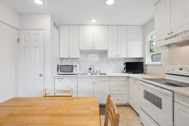 1254 S Yosemite Way Unit 99, Denver, CO 80247 - kitchen with white appliances, a sink, under cabinet range hood, white cabinetry, and recessed lighting