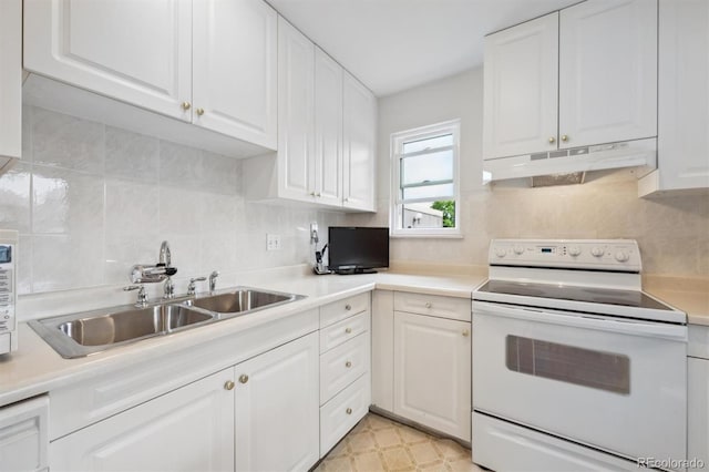 1254 S Yosemite Way Unit 99, Denver, CO 80247 - kitchen featuring electric stove, under cabinet range hood, a sink, white cabinetry, and tasteful backsplash