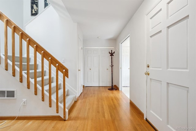 1254 S Yosemite Way Unit 99, Denver, CO 80247 - foyer entrance featuring stairway, light wood-style floors, and baseboards