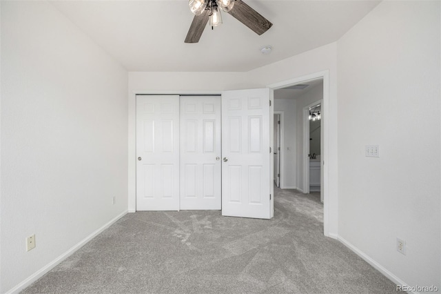unfurnished bedroom with carpet flooring, a ceiling fan, baseboards, and a closet