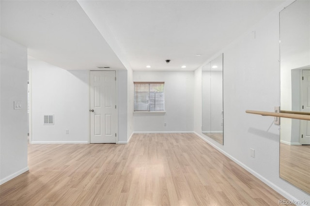unfurnished room with recessed lighting, baseboards, visible vents, and light wood-style flooring