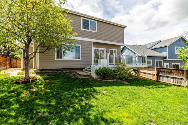 rear view of house with a lawn, a fenced backyard, and a wooden deck