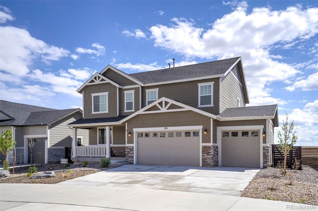 188 S Waterloo St, Aurora, CO 80018 - craftsman-style house with a porch, driveway, fence, stone siding, and an attached garage