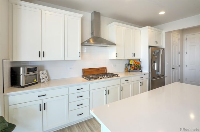 188 S Waterloo St, Aurora, CO 80018 - kitchen featuring stainless steel appliances, wall chimney range hood, light countertops, white cabinets, and recessed lighting