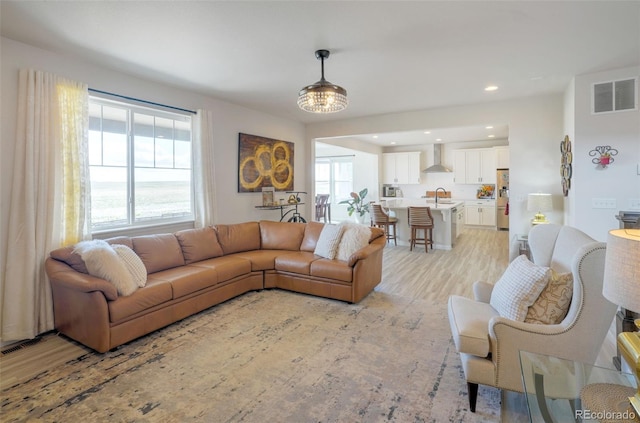 188 S Waterloo St, Aurora, CO 80018 - living room featuring light wood-style floors, plenty of natural light, and recessed lighting