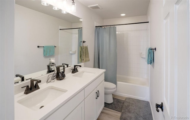 188 S Waterloo St, Aurora, CO 80018 - bathroom featuring toilet, shower / bath combination with curtain, double vanity, and recessed lighting