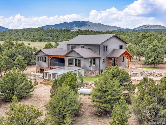 573 Beasley Blvd, Cotopaxi, CO 81223 - back of house featuring dirt driveway, a mountain view, and stone siding