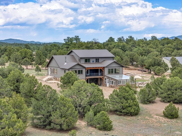 573 Beasley Blvd, Cotopaxi, CO 81223 - rear view of property featuring a metal roof, a wooded view, a mountain view, and dirt driveway