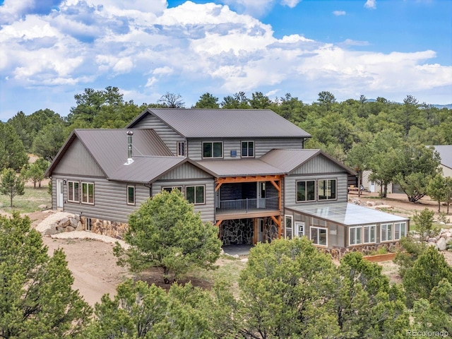 573 Beasley Blvd, Cotopaxi, CO 81223 - back of property featuring stone siding, a metal roof, and dirt driveway