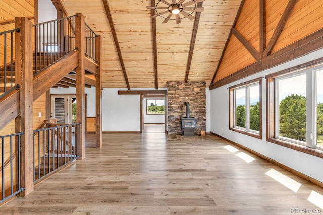 573 Beasley Blvd, Cotopaxi, CO 81223 - unfurnished living room with high vaulted ceiling, a wood stove, wood finished floors, and a wooden ceiling with exposed beams
