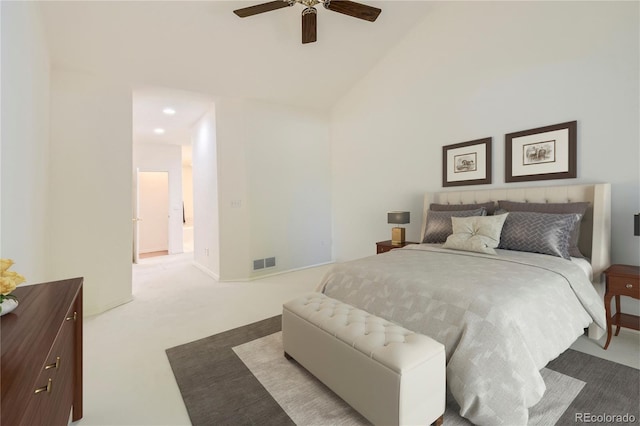 bedroom with ceiling fan, lofted ceiling, and light carpet