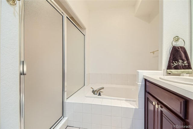 bathroom featuring plus walk in shower and vanity