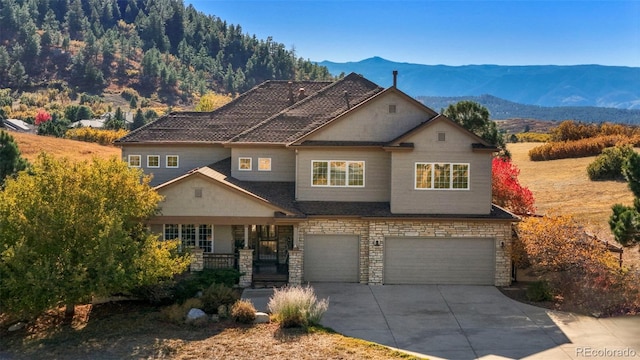 view of front of home featuring a mountain view and a garage