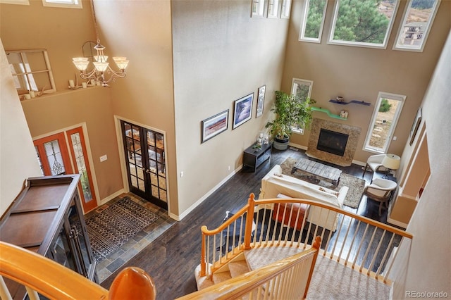 foyer featuring a wealth of natural light, a high ceiling, and dark hardwood / wood-style flooring