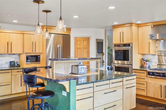 kitchen featuring wall chimney range hood, stainless steel appliances, light brown cabinetry, and a breakfast bar