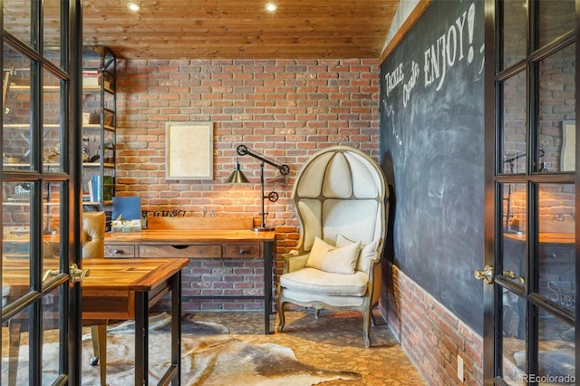 home office with wooden ceiling and brick wall