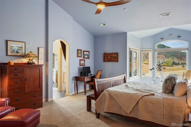 bedroom featuring lofted ceiling, light colored carpet, and ceiling fan