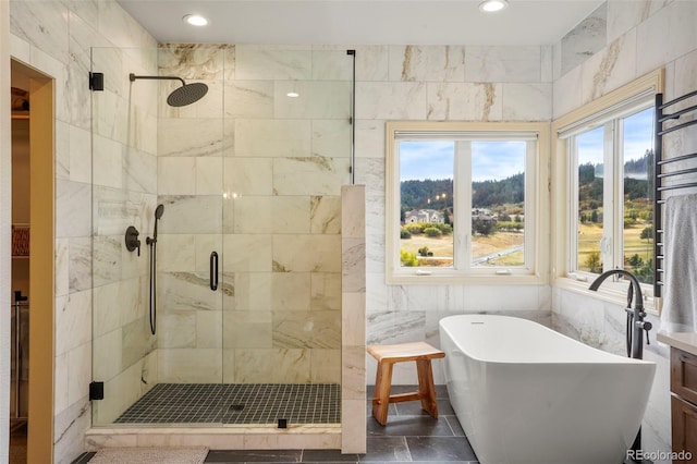 bathroom with tile walls and plus walk in shower