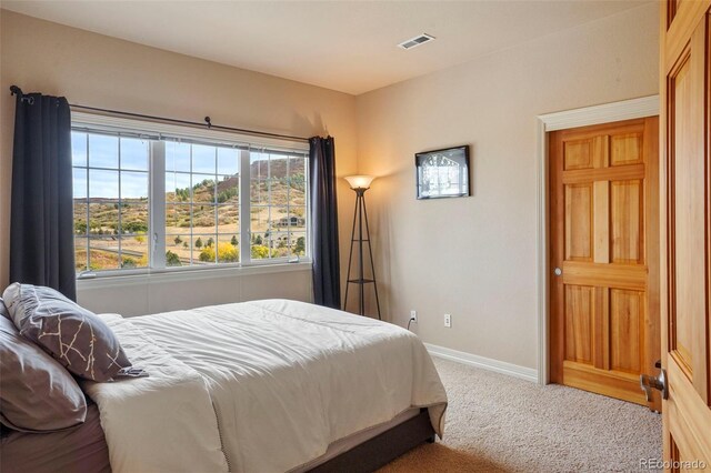 bedroom featuring light carpet