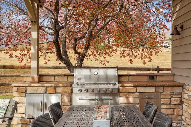 view of patio with area for grilling and exterior kitchen