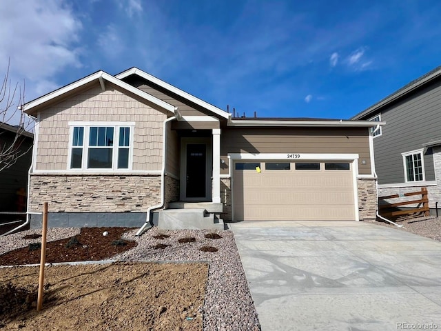 craftsman house with stone siding, concrete driveway, and an attached garage