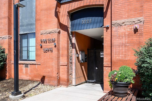 3225 Blake St Unit 4, Denver, CO 80205 - property entrance featuring brick siding and a gate