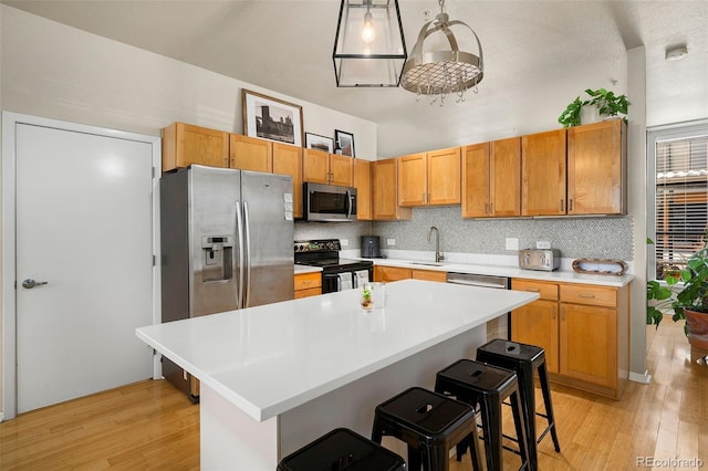 3225 Blake St Unit 4, Denver, CO 80205 - kitchen featuring stainless steel appliances, light wood finished floors, light countertops, and tasteful backsplash
