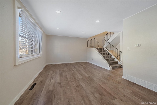 1827 Quail St Unit 3, Lakewood, CO 80215 - unfurnished living room featuring wood finished floors, baseboards, stairs, and recessed lighting