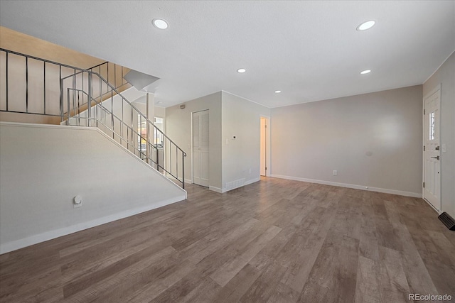 unfurnished living room with hardwood / wood-style flooring