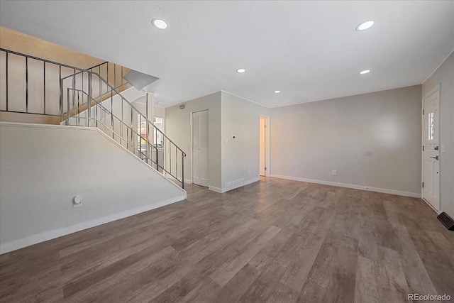 1827 Quail St Unit 3, Lakewood, CO 80215 - unfurnished living room featuring baseboards, recessed lighting, wood finished floors, and stairs