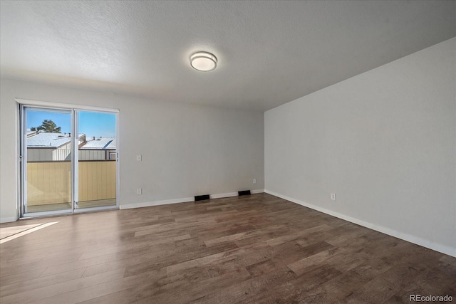 1827 Quail St Unit 3, Lakewood, CO 80215 - unfurnished room with wood finished floors, baseboards, and a textured ceiling
