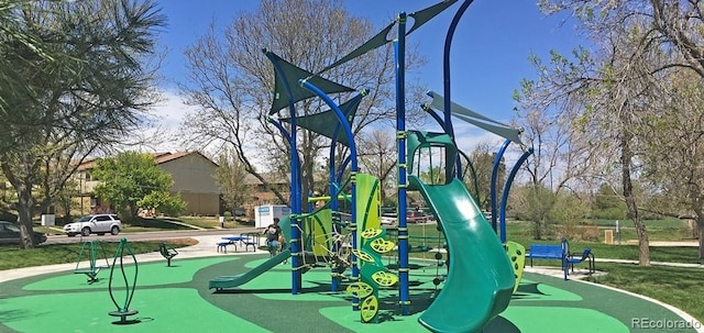 view of playground with a lawn