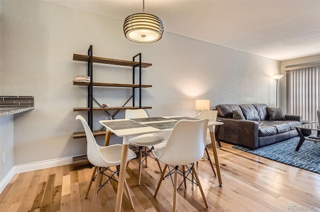 1818 S Quebec Way Unit 11-8, Denver, CO 80231 - dining space with wood-type flooring and baseboards