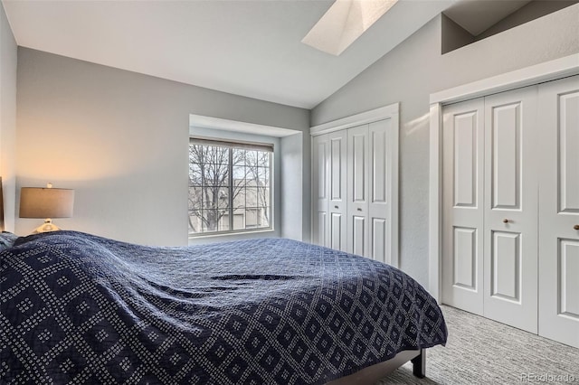 1818 S Quebec Way Unit 11-8, Denver, CO 80231 - carpeted bedroom featuring vaulted ceiling with skylight and two closets