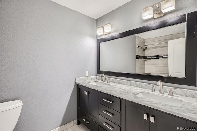 1818 S Quebec Way Unit 11-8, Denver, CO 80231 - full bathroom featuring a sink, a textured wall, toilet, and double vanity