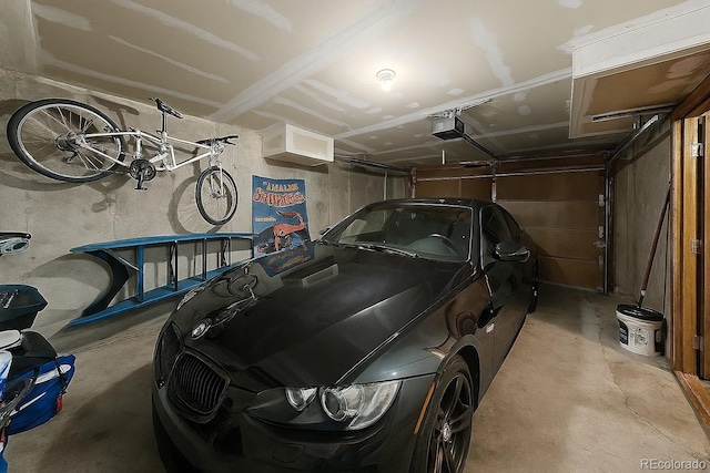 1818 S Quebec Way Unit 11-8, Denver, CO 80231 - garage featuring a garage door opener
